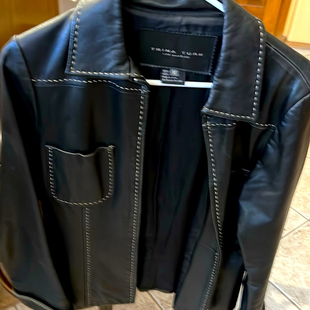 Trina Turk (M) black leather jacket with zipper closure, contrast stitch detail.